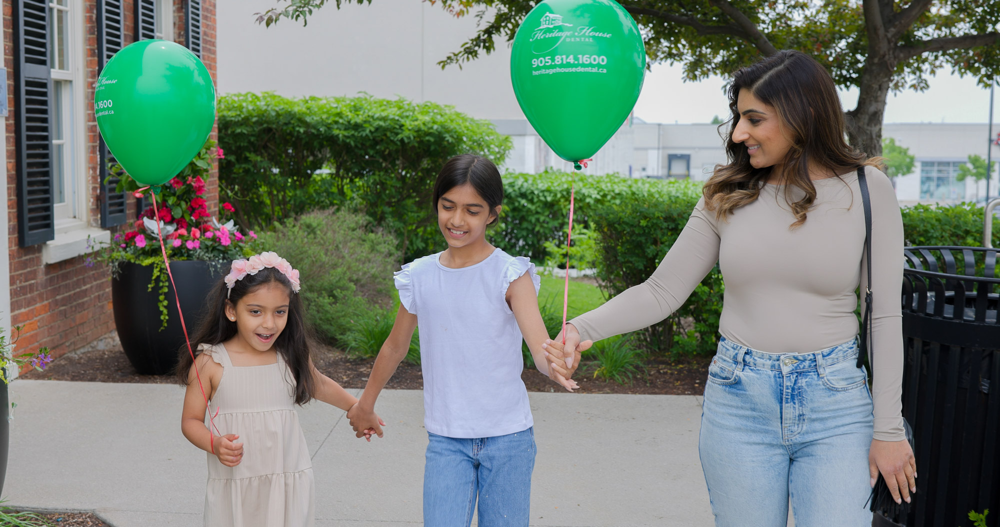 happy kids with green balloons leaving heritage house dental