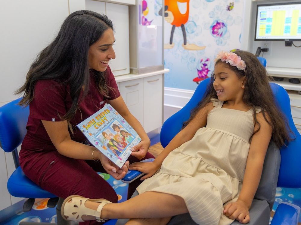 doctor reading to young patient at heritage house dental
